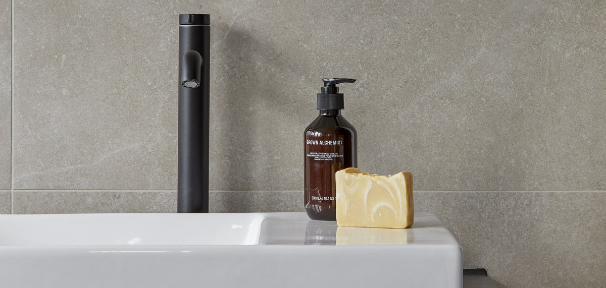 Roca Ona basin mixer in matt black above a white Dash countertop basin
